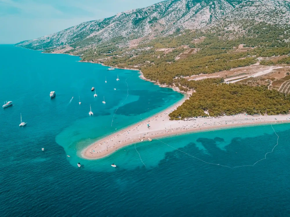 Yachts, sailboats docked near Zlatni Rat Beach on island of Bol